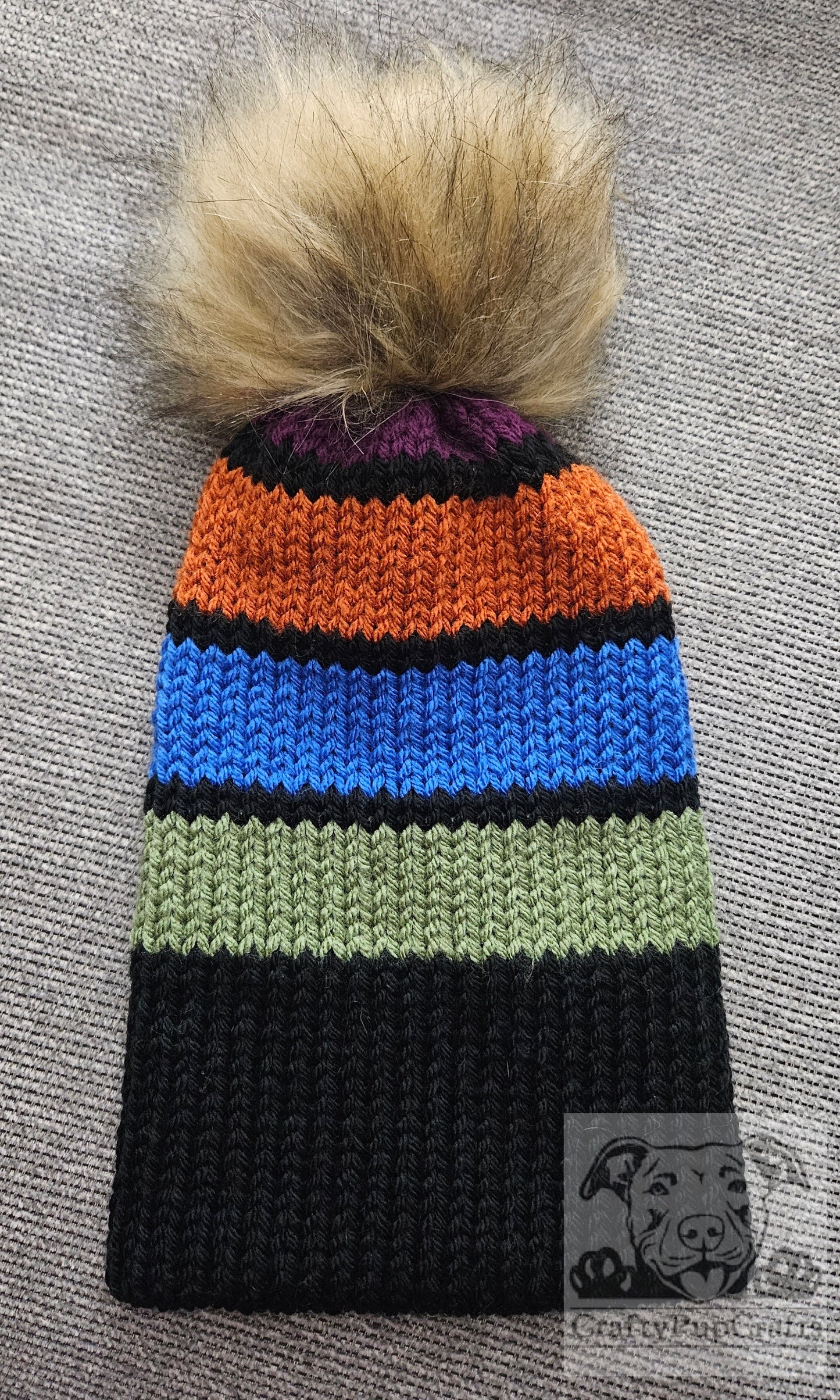 Black & purple/orange/blue/green stripe knit beanie with faux brim and faux fur pom pom